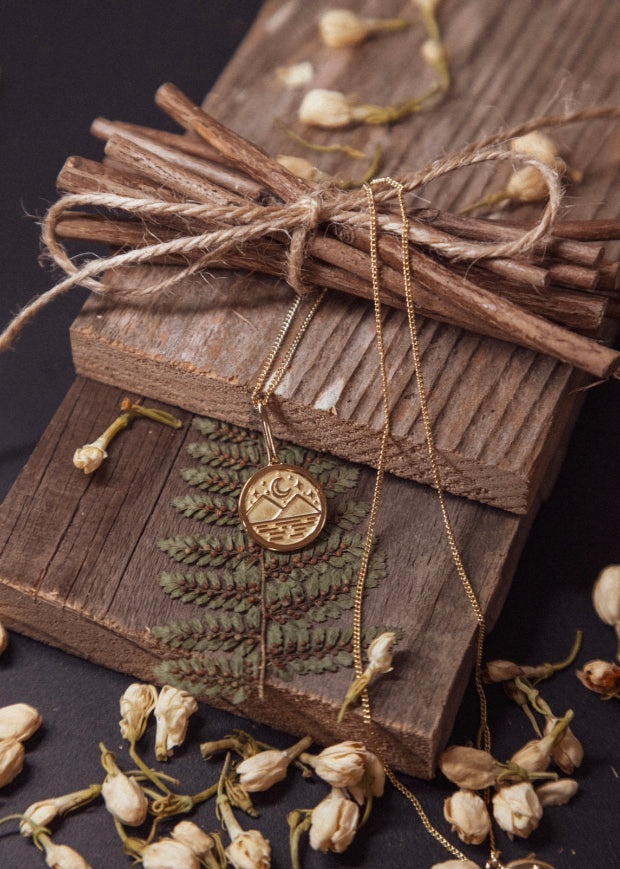 gold vermeil boho mountain necklace with moon and stars macro closeup